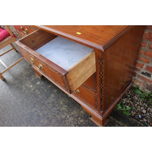 627 - A 1930s carved mahogany dressing chest of two short and two long drawers, on ogee bracket supports a... 