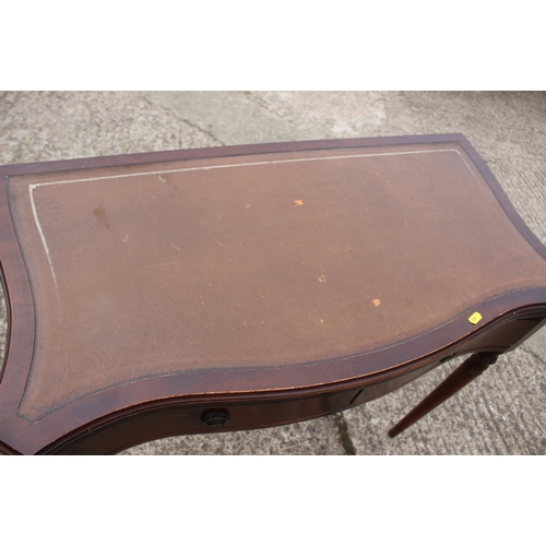 631 - A mahogany and serpentine front fold-over top desk/tea table, on turned and tapering supports