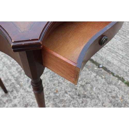 631 - A mahogany and serpentine front fold-over top desk/tea table, on turned and tapering supports