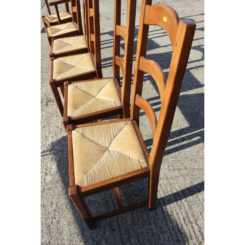 638 - A set of six ladder back dining chairs with rush envelope seats, on stretchered supports (5+1)