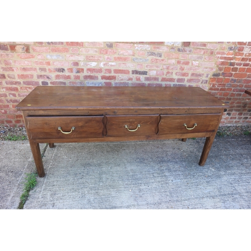 642 - An antique French oak dresser base, fitted three deep drawers, on champhered supports, 72