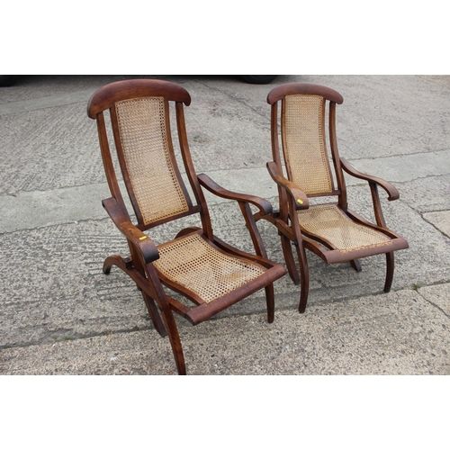 647 - A pair of Edwardian teak and cane seat and back folding steamer chairs