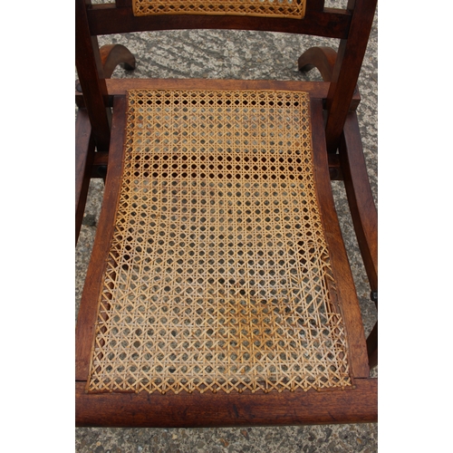 647 - A pair of Edwardian teak and cane seat and back folding steamer chairs