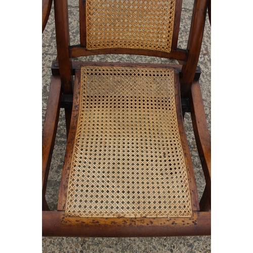 647 - A pair of Edwardian teak and cane seat and back folding steamer chairs