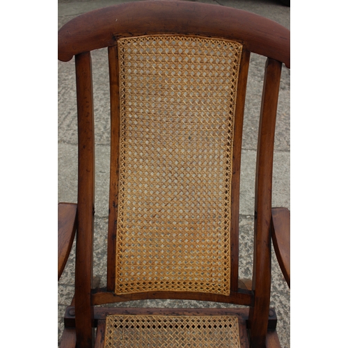 647 - A pair of Edwardian teak and cane seat and back folding steamer chairs