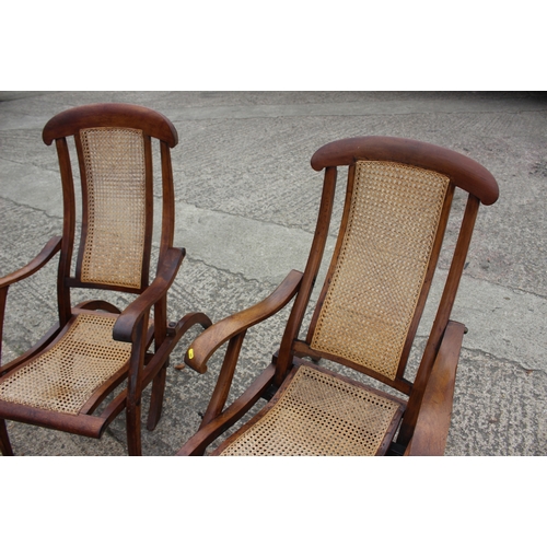 647 - A pair of Edwardian teak and cane seat and back folding steamer chairs