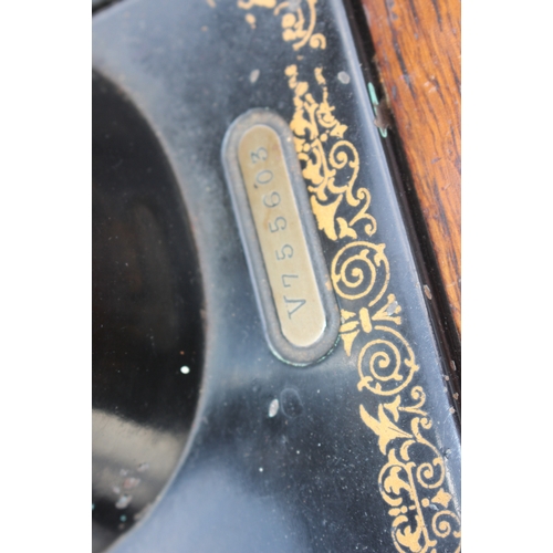 656 - An early 20th century Singer sewing machine, on cast iron treadle frame, 36