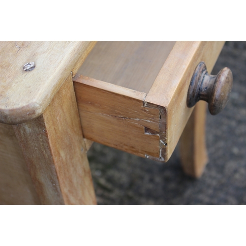 665 - A waxed pine side table, fitted one drawer on turned supports, 28 1/2