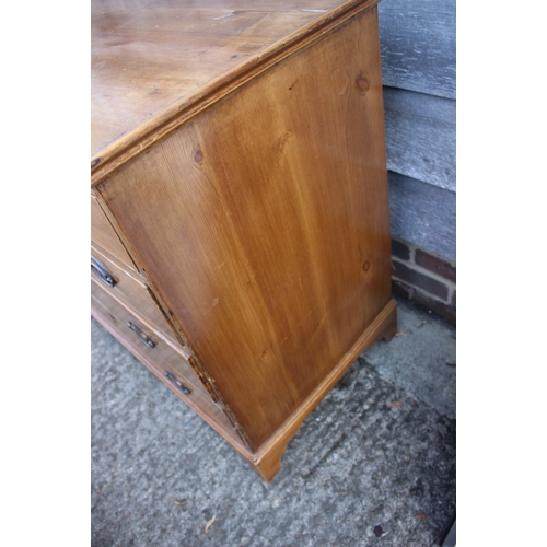 666 - A 19th century waxed pine chest of two short and three long drawers with brass oval handle plates, o... 