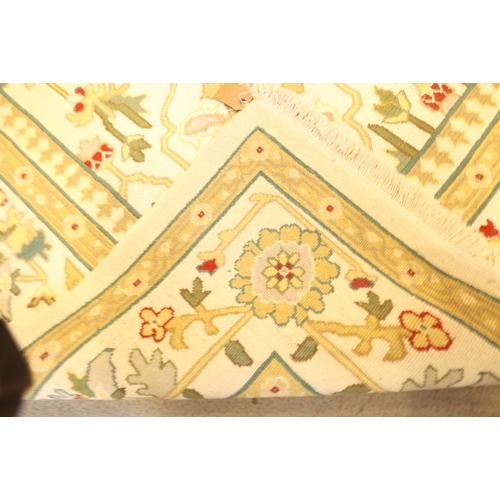 684 - An Indian flat weave/crewelwork carpet with all over geometric design on a cream ground and bird and... 