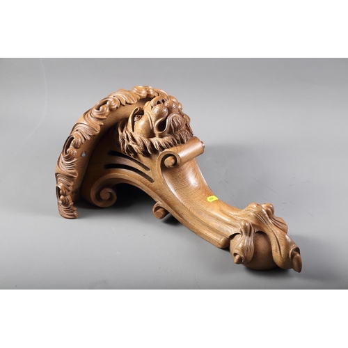 208 - A carved wall bracket, formed as a lion's head with scrolls and talon, 18 1/4