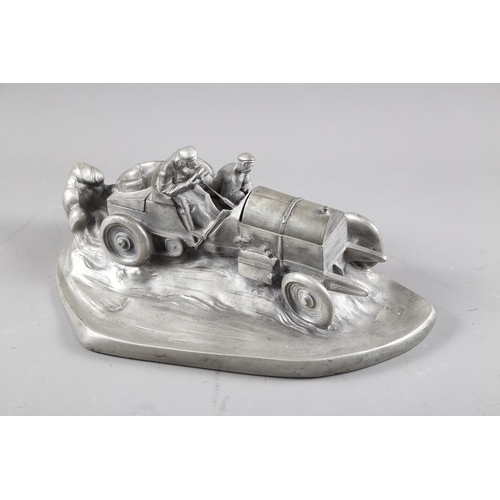 295 - A silvered composition inkwell, in the form of a racing car, signed W Zwick to base, 15 1/2