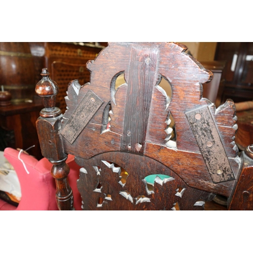 544 - A carved oak side chair of early 17th century design with pierced scrollbar back and stuffed over se... 