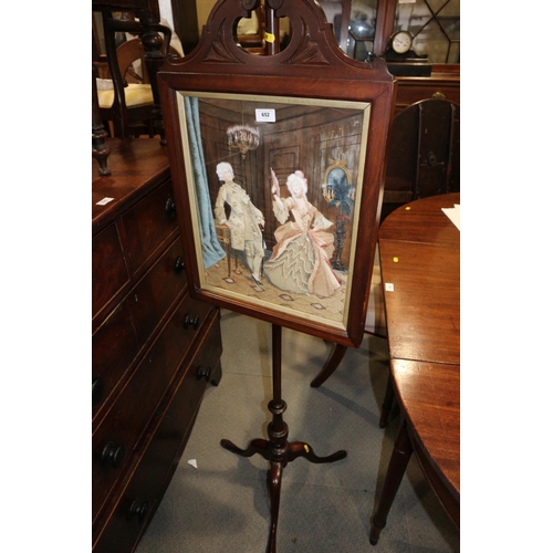 652 - An Edwardian walnut pole fire screen with watercolour and silk embroidered figure decorated panel, o... 