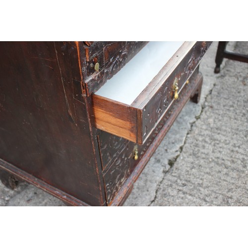 484 - A carved fall front bureau with fitted interior over three graduated drawers on bracket feet, 36