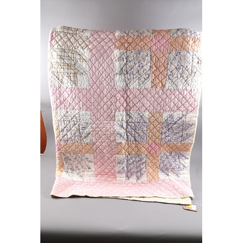 249 - An early 20th century American patchwork quilt with trellis and stars design in shades of pink, oran... 