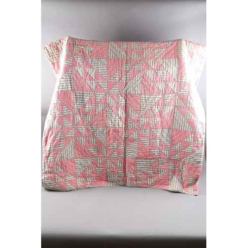 251 - An early 20th century American patchwork quilt with red gingham and grey shaped 