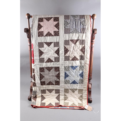 252 - An early 20th century American patchwork quilt with eight-point star and trellis design, 88