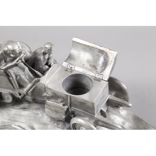 295 - A silvered composition inkwell, in the form of a racing car, signed W Zwick to base, 15 1/2