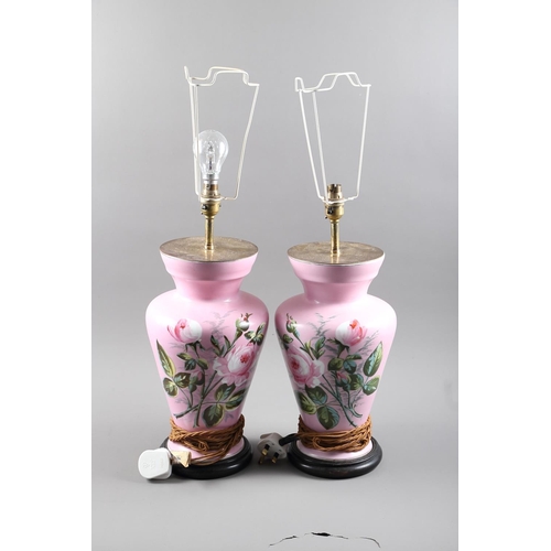 307 - A pair of English table lamps with rose decoration, on a pink ground and ebonised circular bases, 19... 