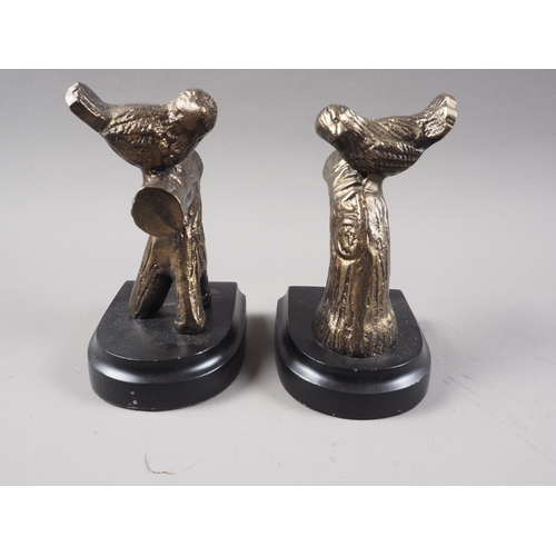 194 - A pair of bronzed bookends, formed as doves on branches, on ebonised plinth bases, 7