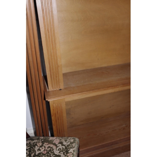 660 - A pine open bookcase with reeded sides, on block base, 58 1/2