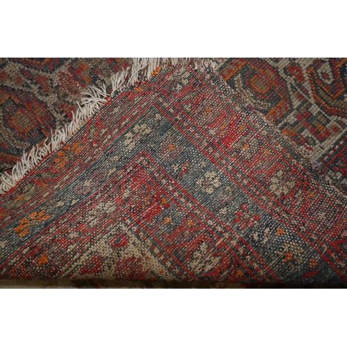 686 - A Herati rug with all-over boteh and animal design on a white ground and triple bordered in shades o... 