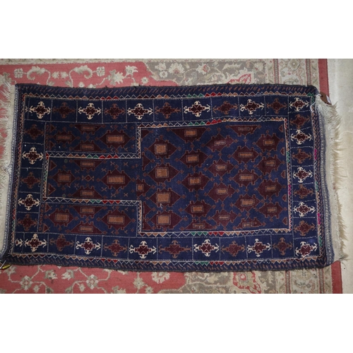 687 - A Bokhara prayer rug with numerous guls on a dark blue ground, 50