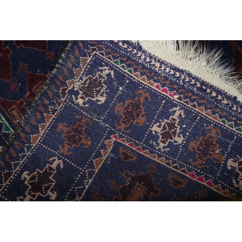 687 - A Bokhara prayer rug with numerous guls on a dark blue ground, 50