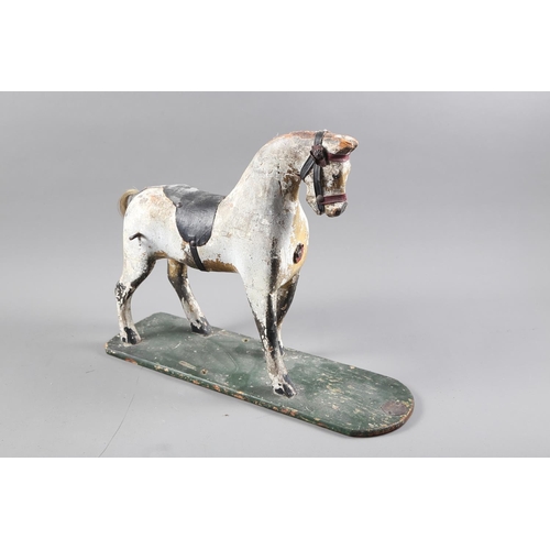 276 - An early 19th century carved wood and painted model horse, on base board, 15