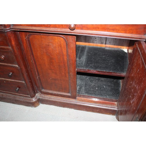 515 - A late Victorian mahogany inverse breakfront bookcase enclosed four glazed doors over cupboards  on ... 