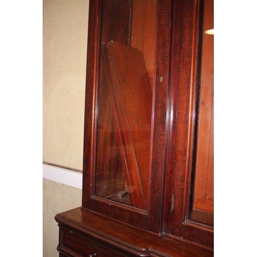 515 - A late Victorian mahogany inverse breakfront bookcase enclosed four glazed doors over cupboards  on ... 