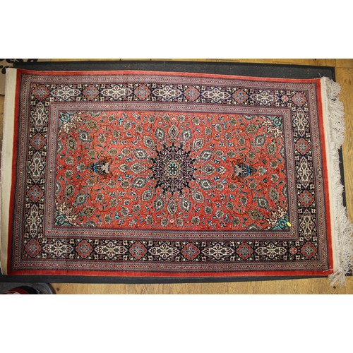 685 - A Kashan/Qum silk wall hanging with central medallion and two lanterns on a red ground and multi-bor... 