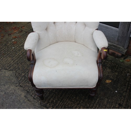 554 - A Victorian showframe armchair, button backed in a magnolia brocade, on turned supports