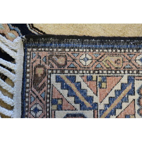 681 - A Persian carpet with blue medallions on a camel ground and multi geometric borders, in shades of bl... 