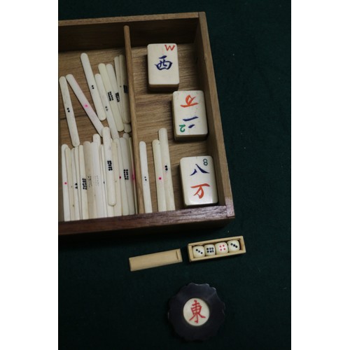 219 - A bone and bamboo Mah-jongg set, in carved hardwood case, and a shove ha'penny board