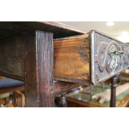 493 - An 18th century provincial carved oak side table, fitted one drawer, on turned and stretchered suppo... 