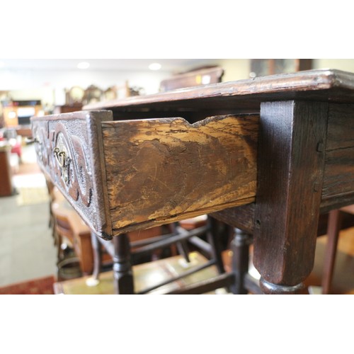 493 - An 18th century provincial carved oak side table, fitted one drawer, on turned and stretchered suppo... 