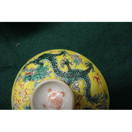 113 - A Chinese yellow glazed rice bowl, cover and stand with dragon decoration, seal mark to base, anothe... 