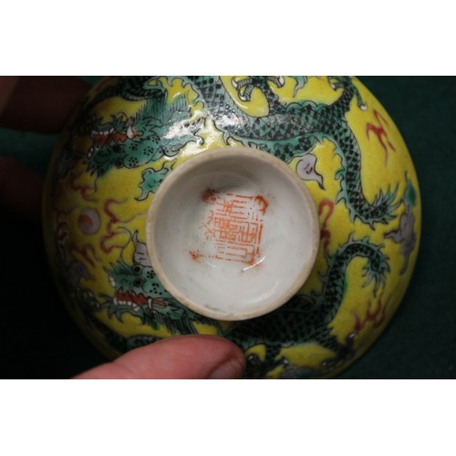 113 - A Chinese yellow glazed rice bowl, cover and stand with dragon decoration, seal mark to base, anothe... 