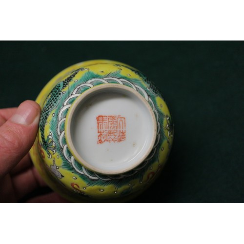 113 - A Chinese yellow glazed rice bowl, cover and stand with dragon decoration, seal mark to base, anothe... 