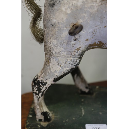 276 - An early 19th century carved wood and painted model horse, on base board, 15