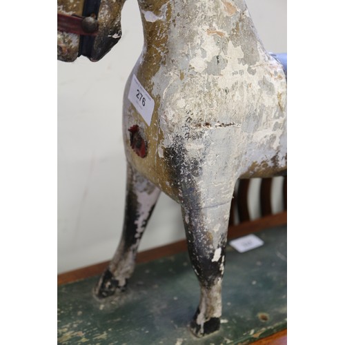 276 - An early 19th century carved wood and painted model horse, on base board, 15