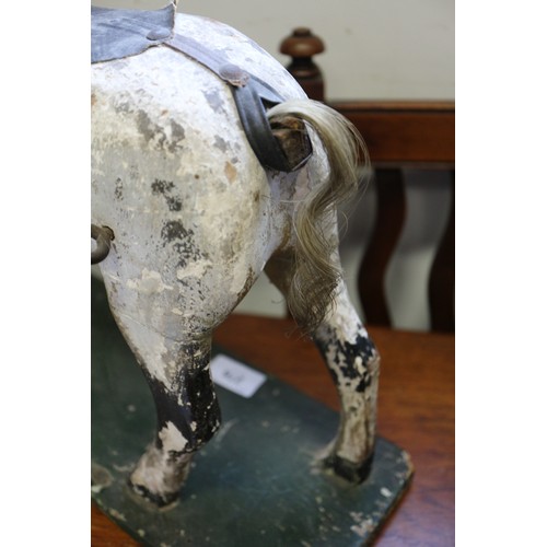 276 - An early 19th century carved wood and painted model horse, on base board, 15