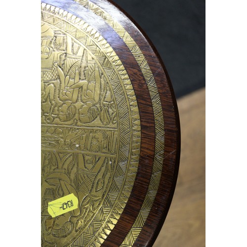 206 - An Egyptian style brass and hardwood circular topped occasional table, on shaped splay supports and ... 