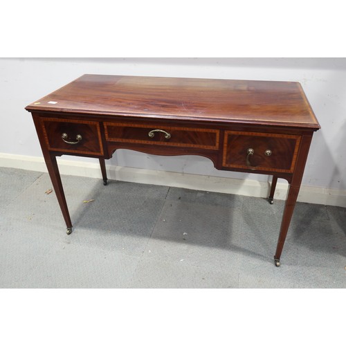 651 - An Edwardian mahogany and banded dressing table, fitted three drawers, on square taper supports, 47