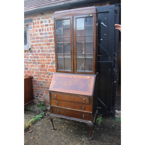 502 - An early 20th century walnut and banded bureau bookcase, the upper section enclosed two doors over f... 