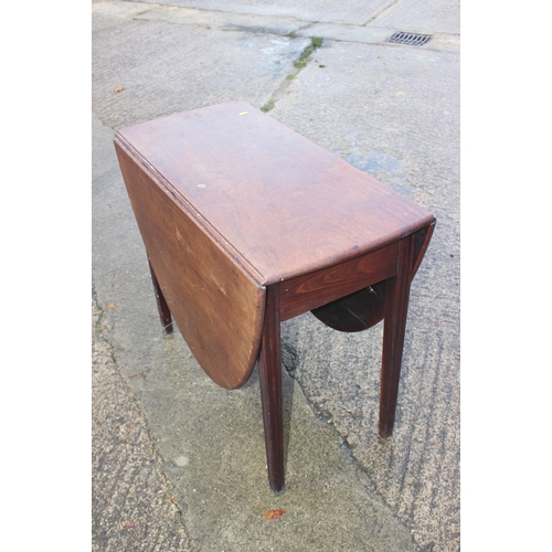 541 - A mahogany oval drop leaf table, on moulded supports, 31 1/2