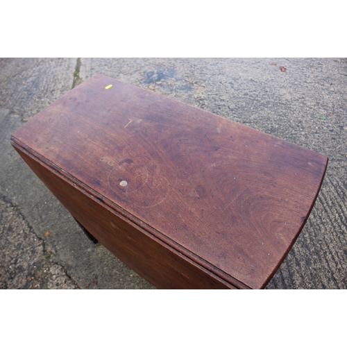 541 - A mahogany oval drop leaf table, on moulded supports, 31 1/2