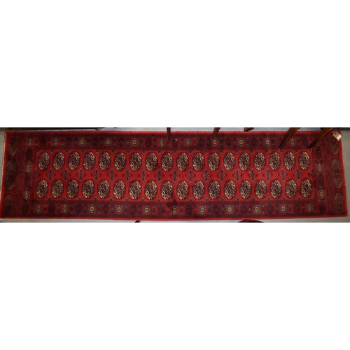 579 - A Bokhara style runner with thirty-six guls in traditional shades, 25